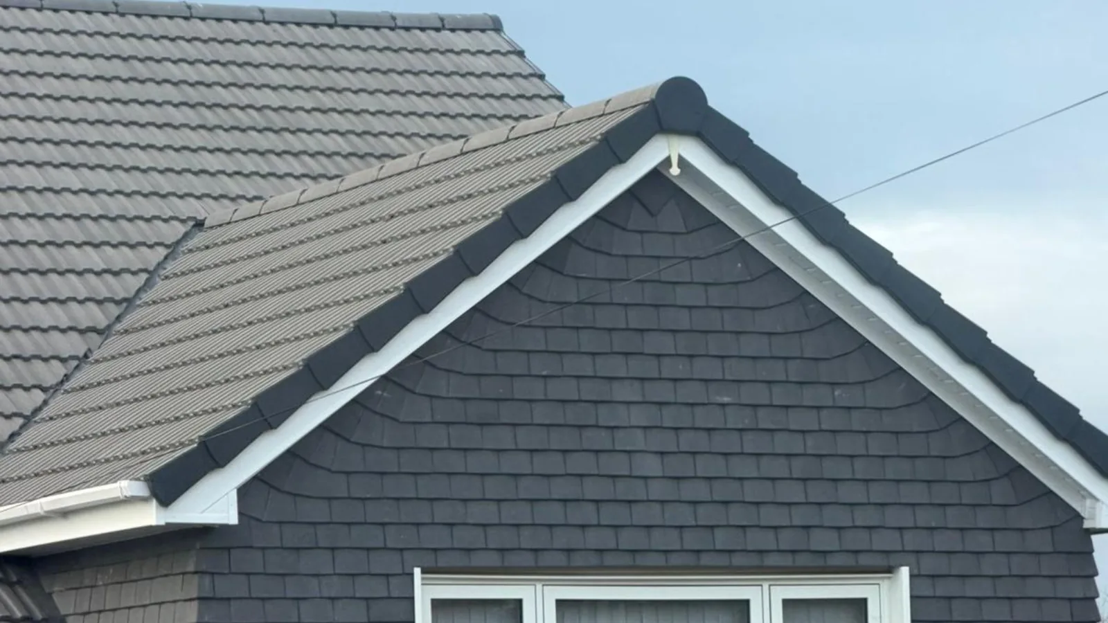 Grey tiled roof and white gable edge